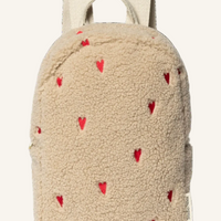 Beige backpack with red heart patterns on a white background