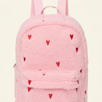 A pink teddy fleece backpack with small red heart details and a front flap pocket, shown on a plain white background.