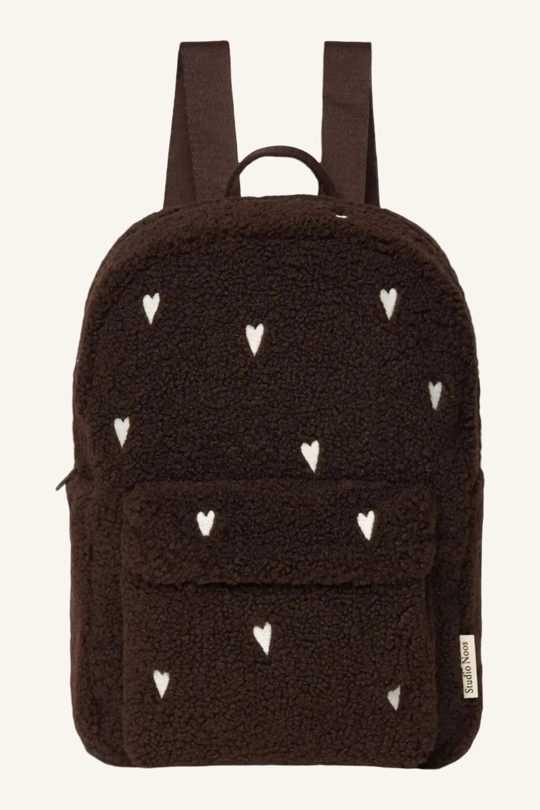A dark brown teddy fleece backpack with a pattern of small white embroidered hearts, featuring a front pocket and dual shoulder straps, shown against a plain white background.
